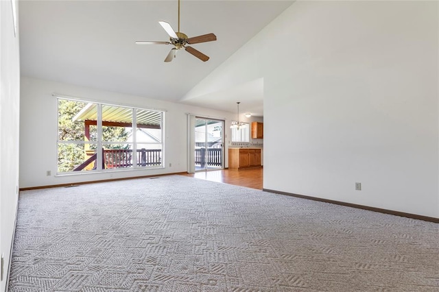 487 Prentice Dr, Ofallon, MO 63376 - unfurnished living room featuring carpet floors, high vaulted ceiling, baseboards, and a ceiling fan