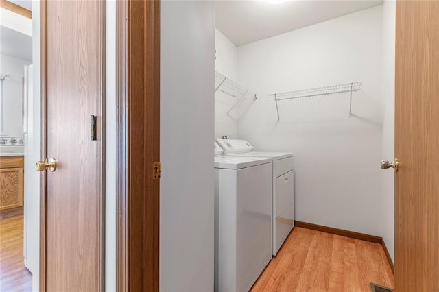 487 Prentice Dr, Ofallon, MO 63376 - laundry room with washing machine and clothes dryer and light wood-style floors