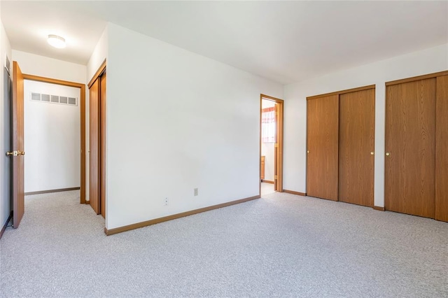 487 Prentice Dr, Ofallon, MO 63376 - unfurnished bedroom with two closets, carpet floors, and baseboards