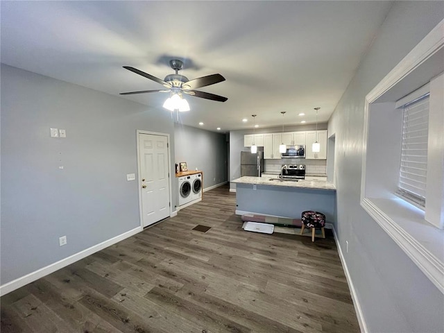 2715 Arkansas Ave, Saint Louis, MO 63118 - kitchen with appliances with stainless steel finishes, washing machine and clothes dryer, white cabinets, dark wood-style floors, and recessed lighting