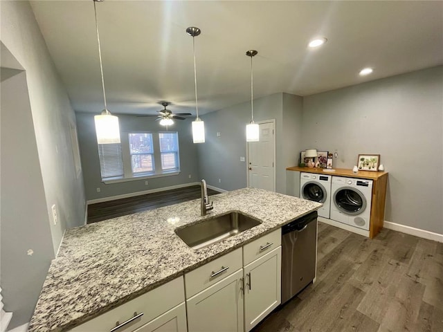2715 Arkansas Ave, Saint Louis, MO 63118 - kitchen with a sink, dishwasher, washing machine and clothes dryer, dark wood-type flooring, and recessed lighting