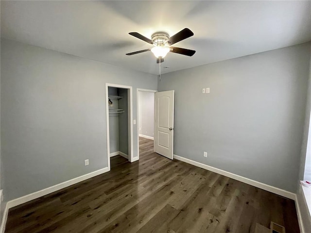 2715 Arkansas Ave, Saint Louis, MO 63118 - unfurnished bedroom with dark wood-style floors, baseboards, a closet, and a ceiling fan
