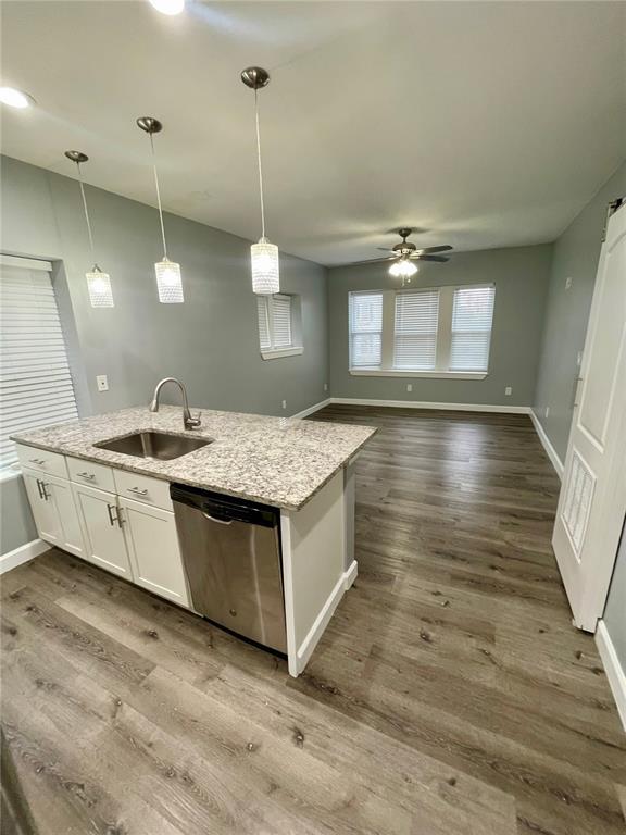 2715 Arkansas Ave, Saint Louis, MO 63118 - kitchen with a sink, dishwasher, white cabinets, ceiling fan, and baseboards