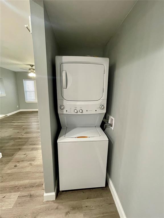 2715 Arkansas Ave, Saint Louis, MO 63118 - laundry room featuring estacked washer and dryer, wood finished floors, ceiling fan, and baseboards