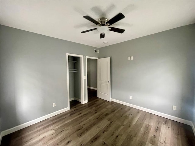 2715 Arkansas Ave, Saint Louis, MO 63118 - unfurnished bedroom with baseboards, a closet, dark wood-style floors, and ceiling fan