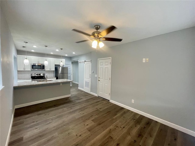 2715 Arkansas Ave, Saint Louis, MO 63118 - kitchen featuring stainless steel appliances, white cabinets, dark wood-style floors, baseboards, and recessed lighting