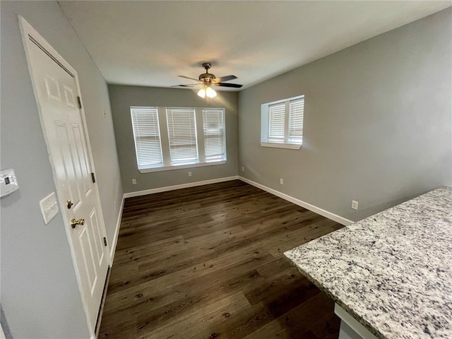 2715 Arkansas Ave, Saint Louis, MO 63118 - unfurnished bedroom with dark wood finished floors, baseboards, and a ceiling fan