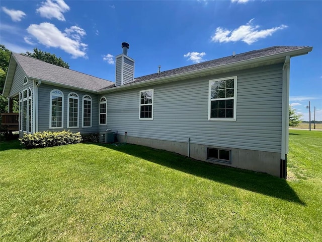 7867 Lebanon Rd, Troy, IL 62294 - back of property with a lawn, central air condition unit, and a chimney