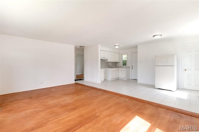 8115 Myrick St, Berkeley, MO 63134 - unfurnished living room with light wood finished floors and baseboards