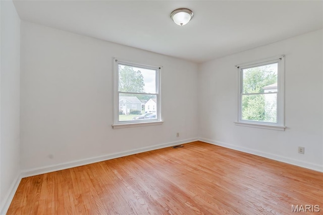 8115 Myrick St, Berkeley, MO 63134 - spare room featuring healthy amount of natural light, wood finished floors, and baseboards