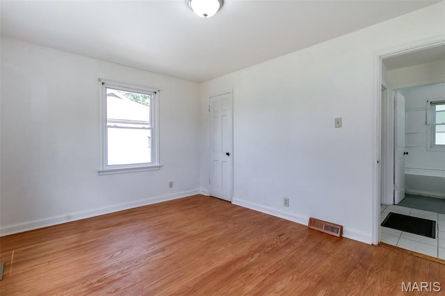 8115 Myrick St, Berkeley, MO 63134 - unfurnished room featuring light wood-type flooring, plenty of natural light, and baseboards