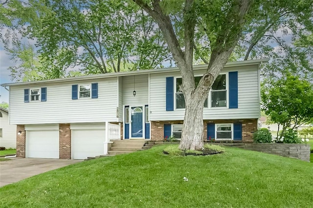 raised ranch featuring brick siding, an attached garage, and concrete driveway