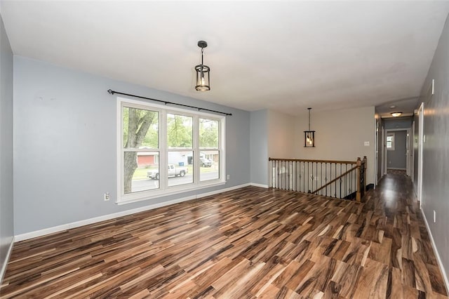 unfurnished room featuring wood finished floors and baseboards