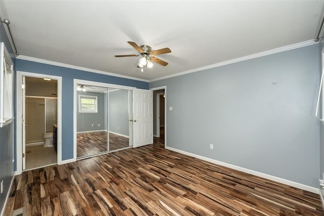 unfurnished bedroom with dark wood-style flooring, baseboards, a closet, ornamental molding, and connected bathroom