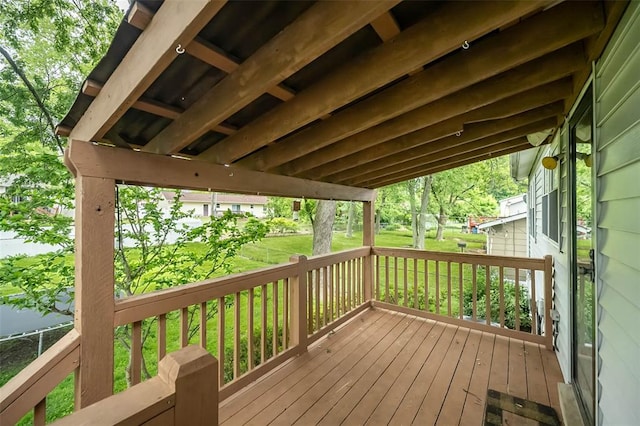 wooden terrace featuring a yard