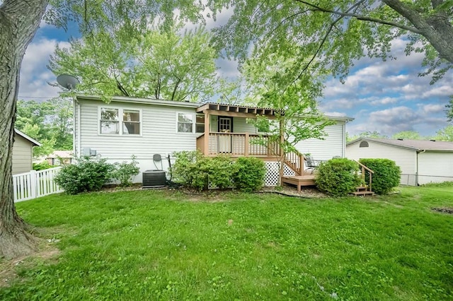 rear view of house featuring a wooden deck