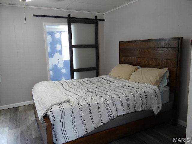 127 E 2nd St, De Soto, MO 63020 - bedroom featuring wood finished floors, a barn door, and crown molding