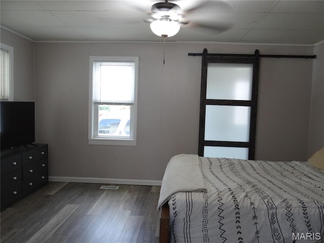 127 E 2nd St, De Soto, MO 63020 - bedroom featuring wood finished floors, a barn door, crown molding, and ceiling fan