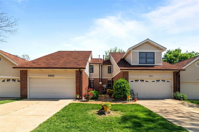 5621 Duchesne Parque Dr, Saint Louis, MO 63128 - view of front of home with brick siding, driveway, and a front lawn