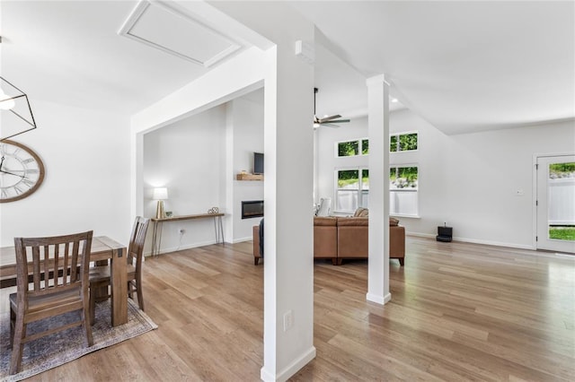 1513 Grey Wolf Dr, Imperial, MO 63052 - dining area with healthy amount of natural light, light wood-type flooring, a glass covered fireplace, and ceiling fan