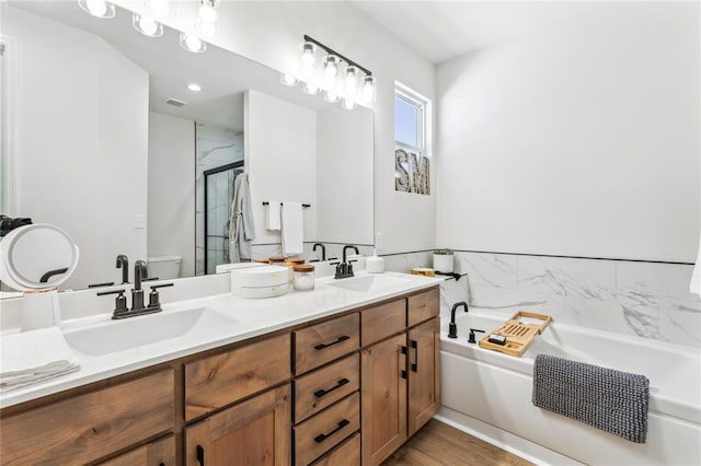 1513 Grey Wolf Dr, Imperial, MO 63052 - bathroom featuring a garden tub, double vanity, a shower stall, and toilet