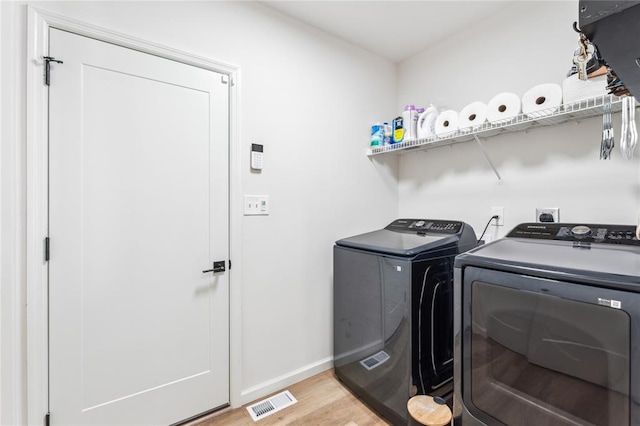 1513 Grey Wolf Dr, Imperial, MO 63052 - washroom featuring washer and clothes dryer, light wood-style flooring, and baseboards