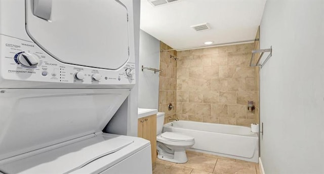 4220 Mcpherson Unit 101, Saint Louis, MO 63108 - full bath with stacked washer and clothes dryer, tile patterned flooring, bathing tub / shower combination, toilet, and vanity
