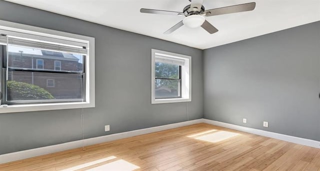 4220 Mcpherson Unit 101, Saint Louis, MO 63108 - empty room with wood finished floors, baseboards, and a ceiling fan