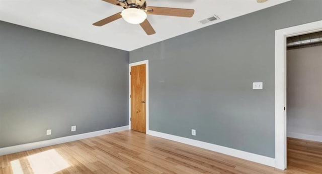 4220 Mcpherson Unit 101, Saint Louis, MO 63108 - unfurnished bedroom with wood finished floors, baseboards, a closet, and a ceiling fan