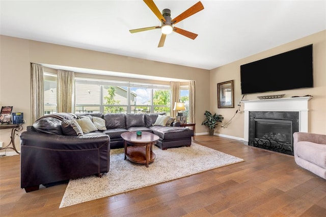 2 Autumn Bluffs Ct, Fenton, MO 63026 - living area featuring ceiling fan, wood finished floors, a glass covered fireplace, and baseboards