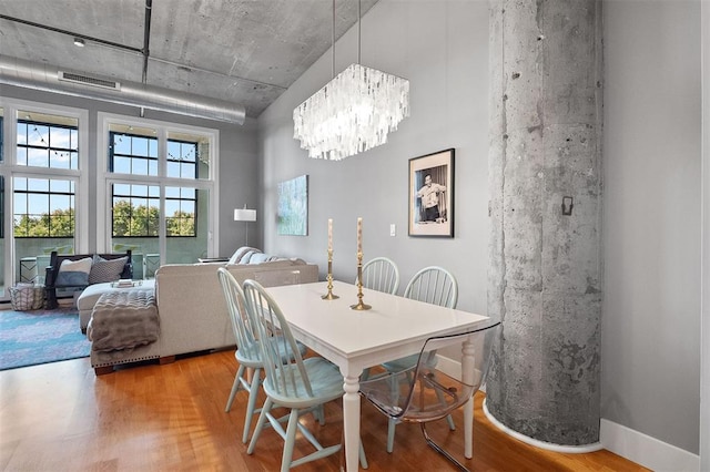 4100 Forest Park Ave Unit 323, Saint Louis, MO 63108 - dining space with wood finished floors and a chandelier