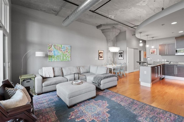 4100 Forest Park Ave Unit 323, Saint Louis, MO 63108 - living room with light wood finished floors and a high ceiling