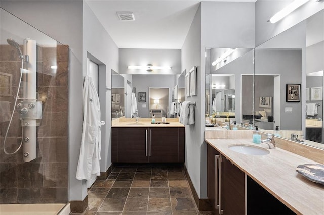 4100 Forest Park Ave Unit 323, Saint Louis, MO 63108 - full bathroom with tiled shower, baseboards, vanity, and stone finish floors