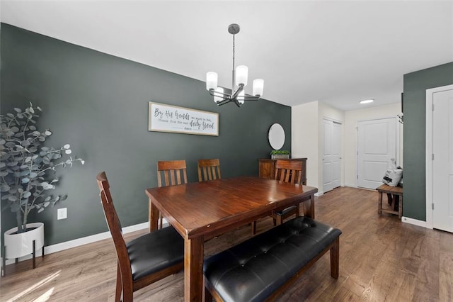 224 Quiet Bend Dr, Wentzville, MO 63385 - dining room with a chandelier, wood finished floors, and baseboards