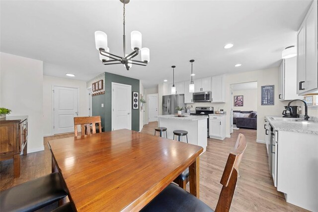 224 Quiet Bend Dr, Wentzville, MO 63385 - dining space with a chandelier, recessed lighting, light wood finished floors, and baseboards