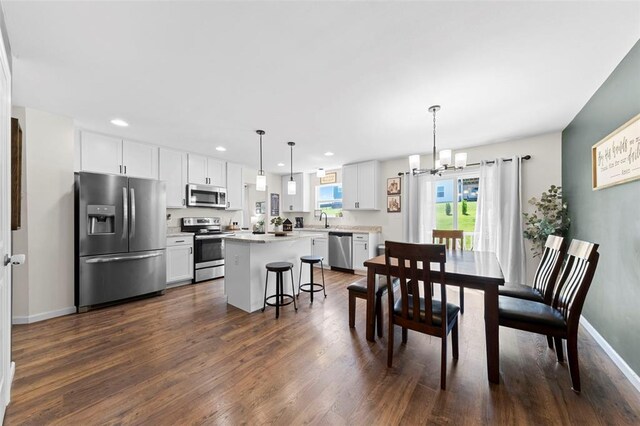 224 Quiet Bend Dr, Wentzville, MO 63385 - dining area featuring dark wood finished floors, a chandelier, recessed lighting, and baseboards