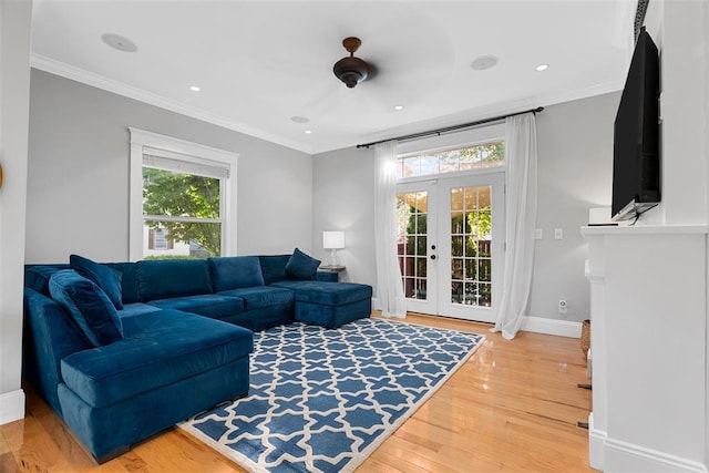 living room with french doors, wood finished floors, baseboards, crown molding, and recessed lighting