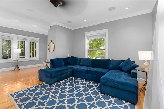 living area with wood finished floors, baseboards, crown molding, and recessed lighting