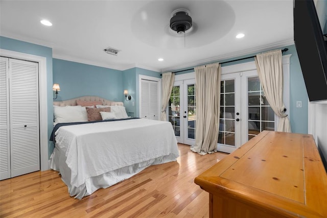 bedroom featuring french doors, ornamental molding, access to exterior, light wood-type flooring, and multiple closets