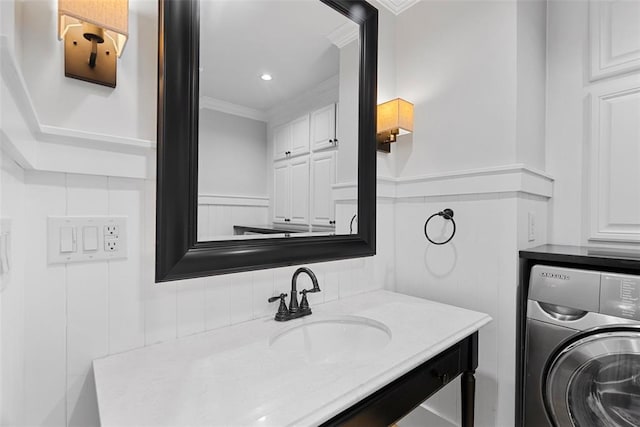 bathroom with washer / clothes dryer, crown molding, and vanity