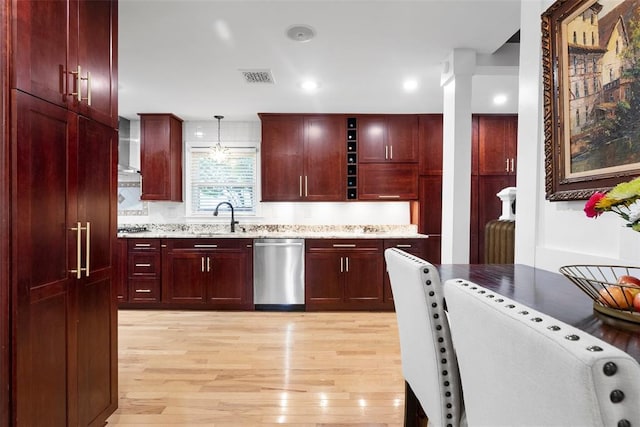 kitchen featuring dark brown cabinets, stainless steel dishwasher, light wood-style floors, and recessed lighting