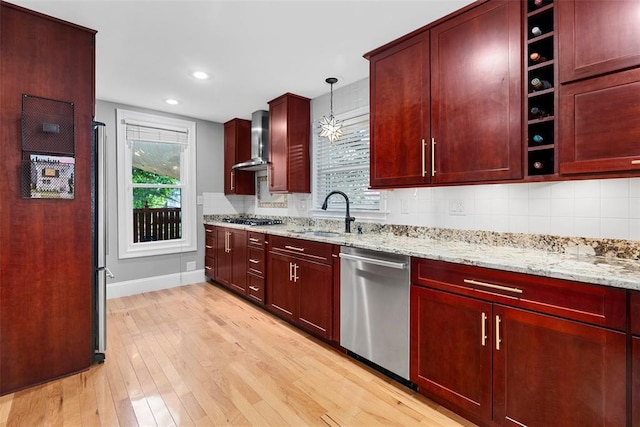 kitchen with stainless steel appliances, a sink, dark brown cabinets, and recessed lighting