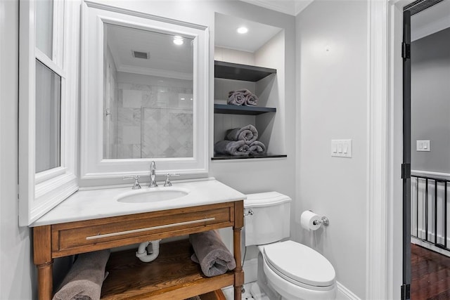 full bathroom with ornamental molding, toilet, vanity, and baseboards