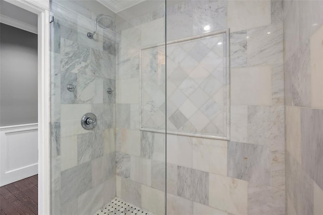 full bathroom with crown molding and a shower stall