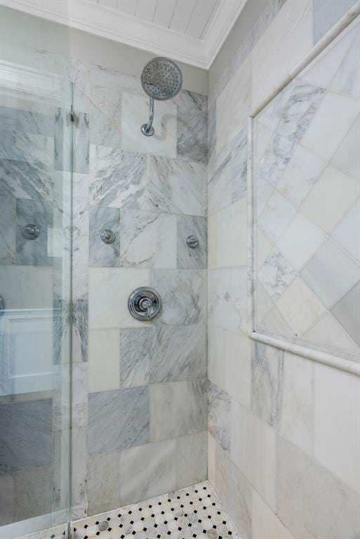 full bathroom with a shower stall and crown molding