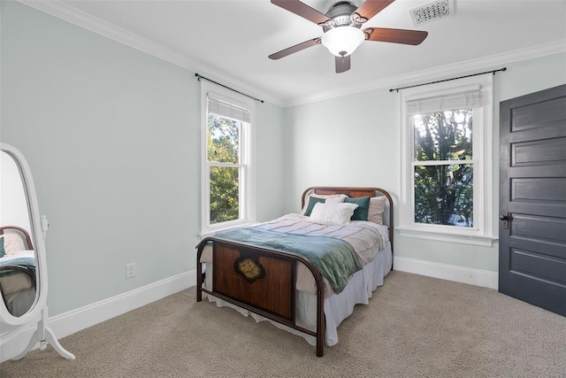 bedroom with crown molding, baseboards, light colored carpet, and ceiling fan