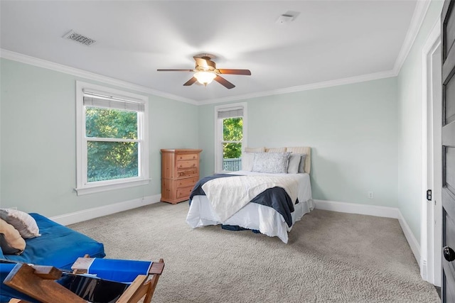 bedroom featuring baseboards, ornamental molding, carpet, and a ceiling fan