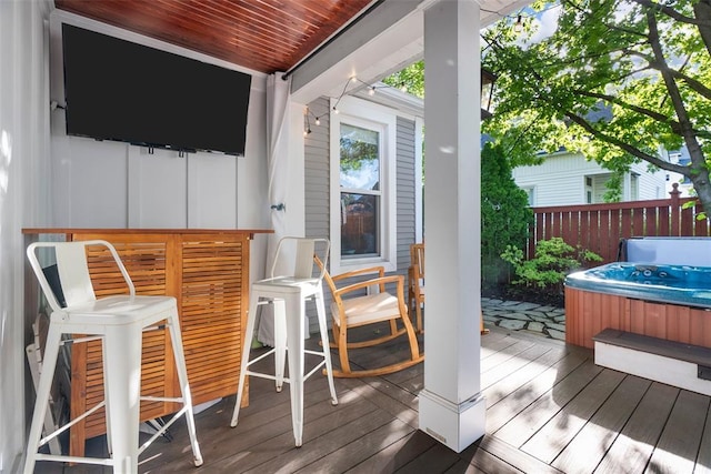wooden terrace featuring a hot tub