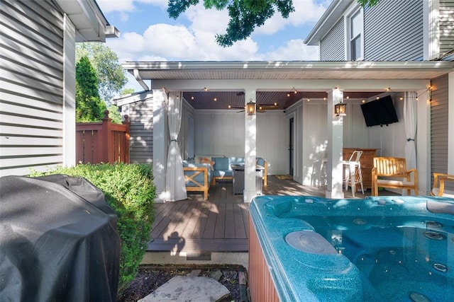 deck featuring a grill, outdoor lounge area, and fence