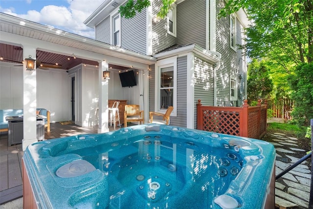 wooden terrace featuring a hot tub and a grill